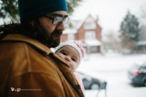 baby in carrier on snow day
