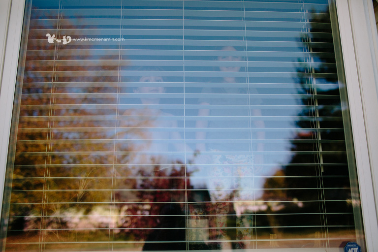kids looking out a window on a fall day