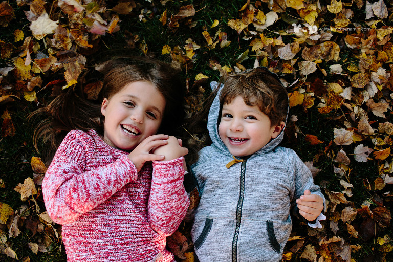 little kids in fall leaves