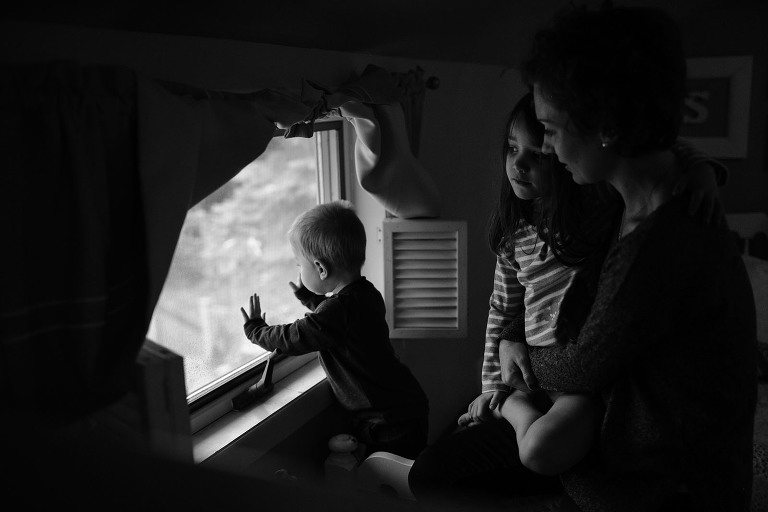 kids and mom looking out window