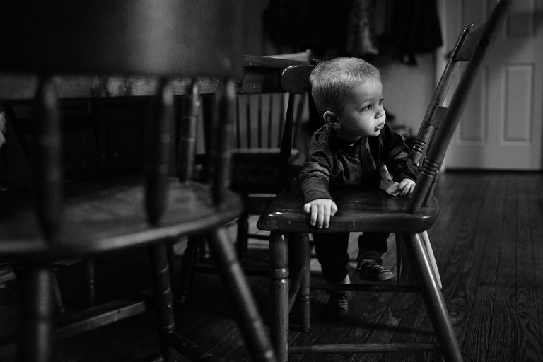 toddler climbing onto chair