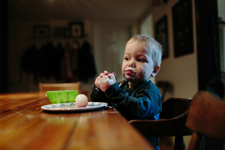 little boy eating yogurt