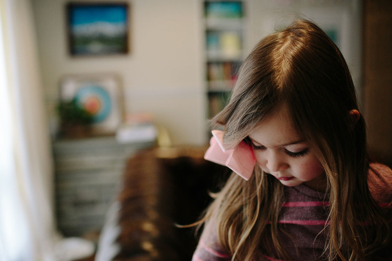 little girl looking down, lashes
