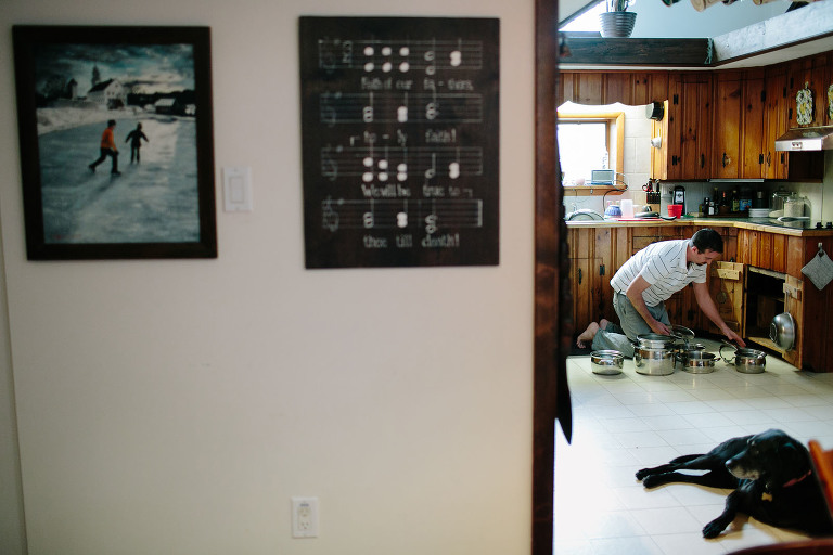 dad organizing pots in kitchen