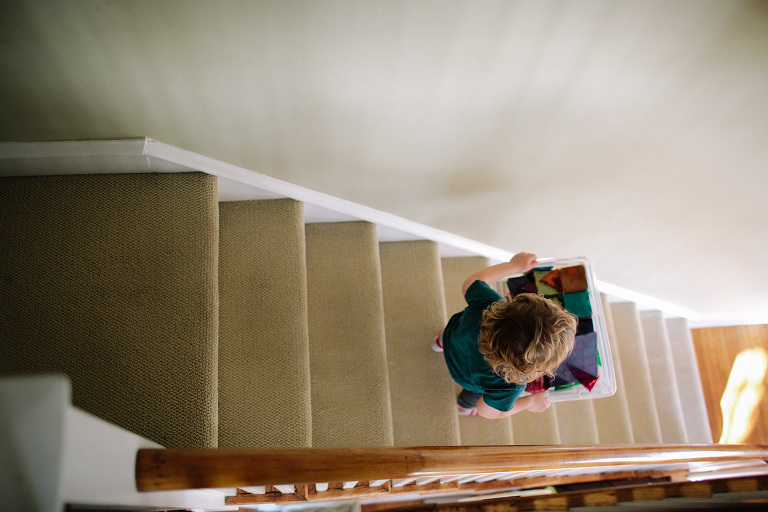 carrying magnatiles downstairs family photography