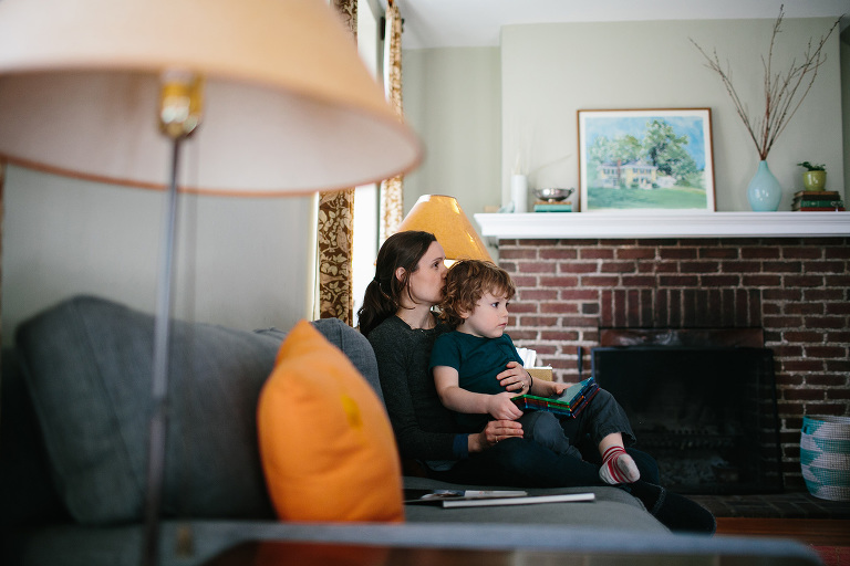 mom and son snuggling on couch in home family session