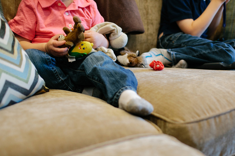 toddler's hands full of stuffed animals