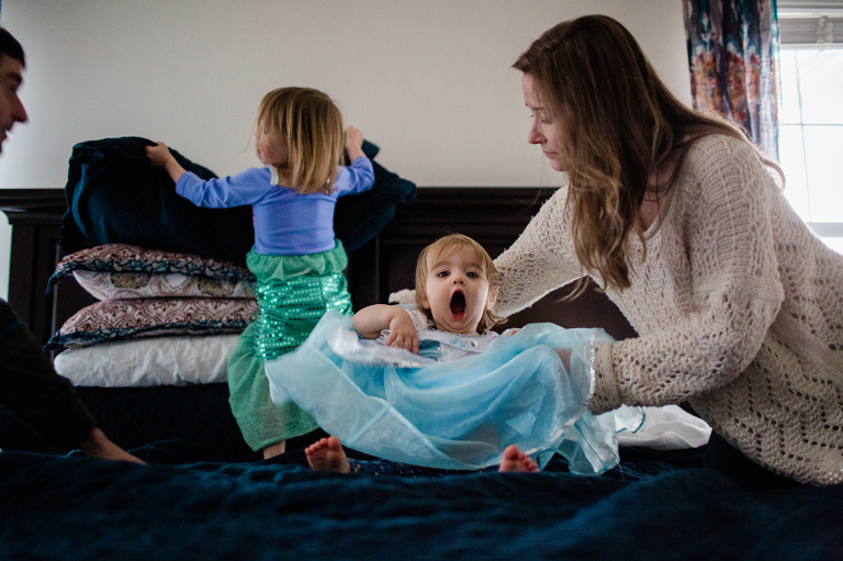 documentary image of toddler girl making a silly face with her mom