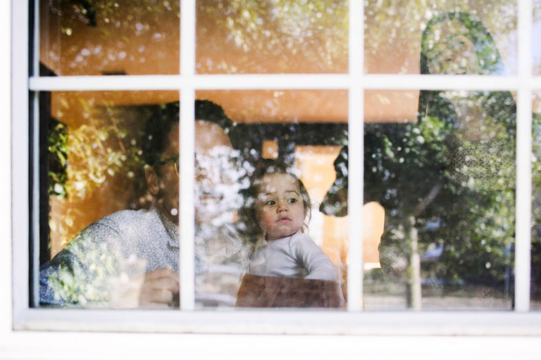 photograph of family through the window of their wynnewood home