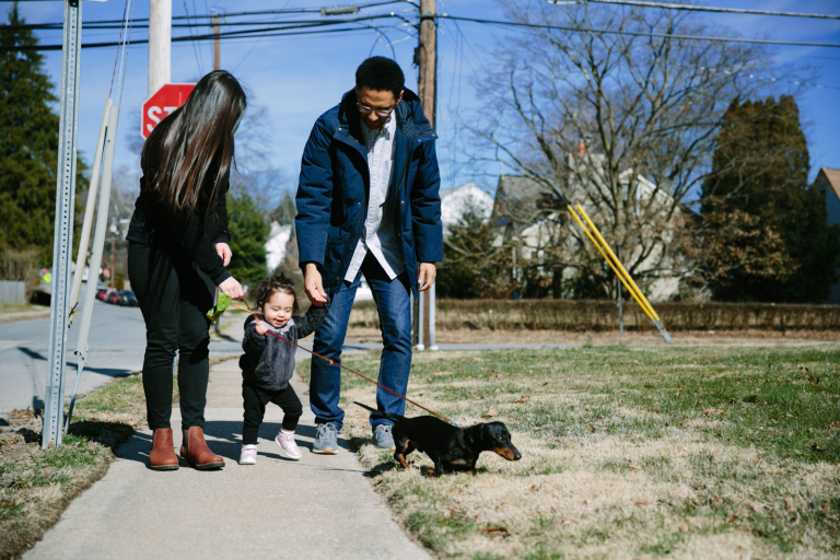 Image of mom, dad and toddler girl walking their dog in Wynnewood