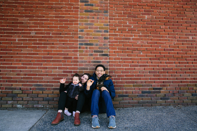 Lifestyle image of family sitting in front of a brick wall in Wynnewood