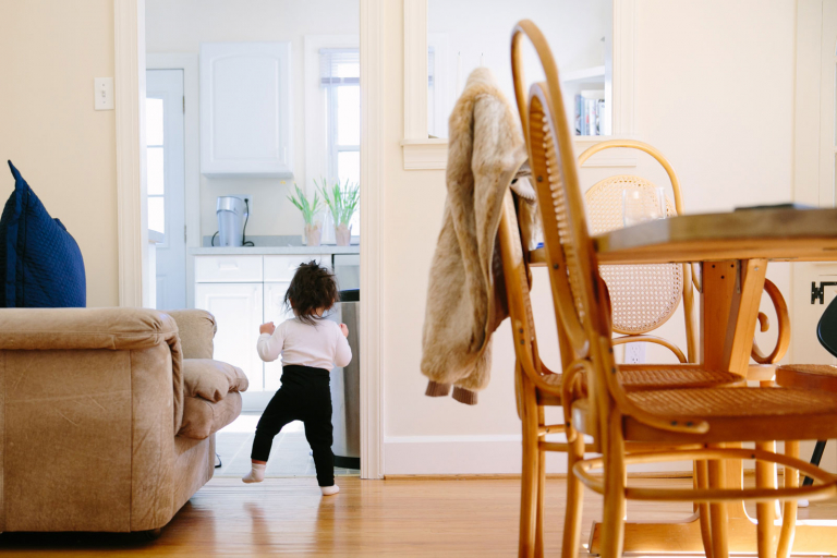Documentary Image of toddler girl walk from behind. 