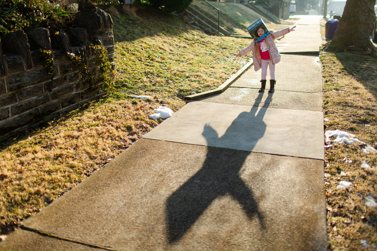 Conshohocken Documentary Photo of girl with robot helmet on on sidewalk with large shadow