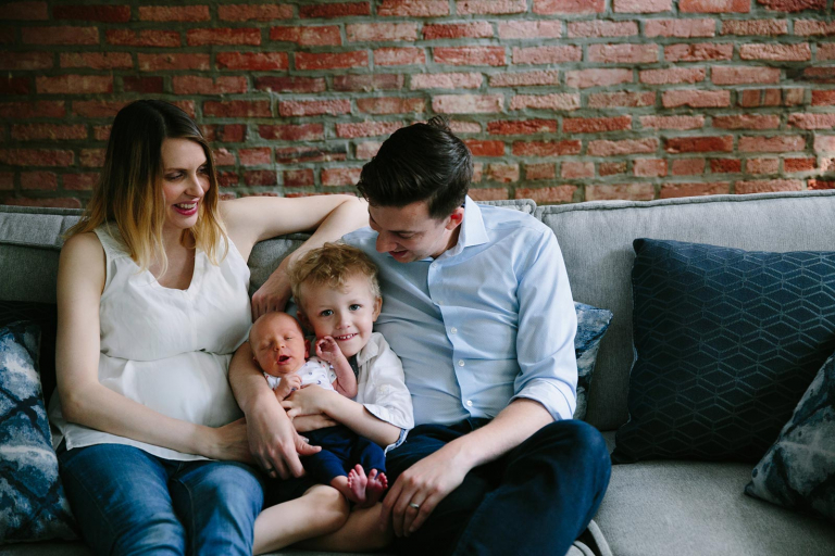 Family photograph with parents, little boy and newborn baby