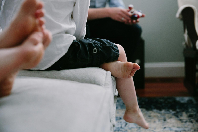 Closeup of little boy's foot on the couch 