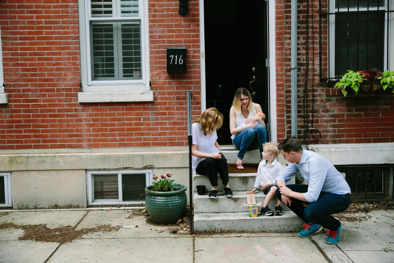 Philadelphia documentary photography of family sitting on front step playing with chalk