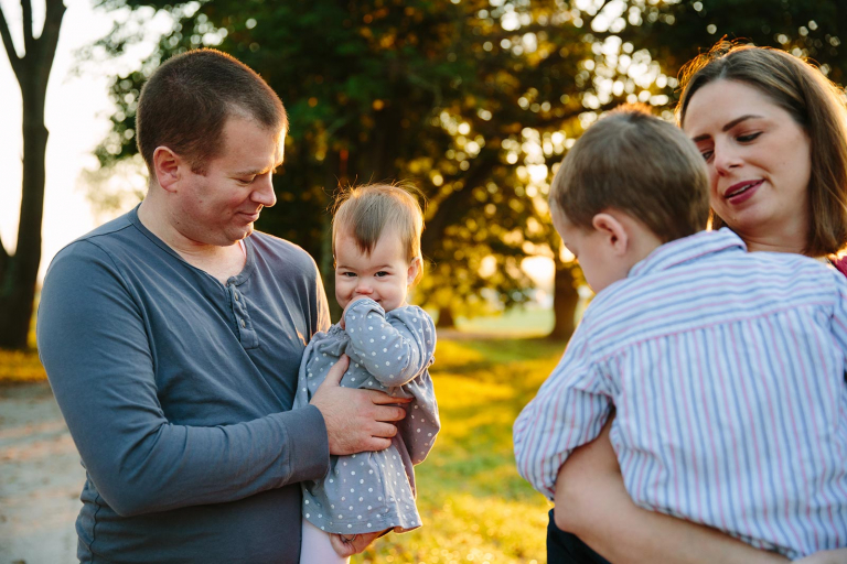 Photo of dad and daughter in the background and mom and son in the foreground