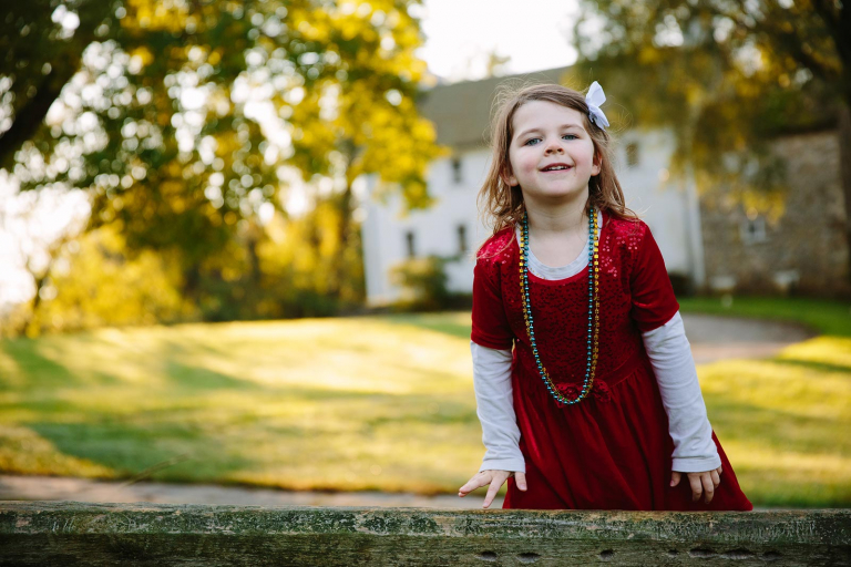 Photo at valley forge of little girl standing on a fence