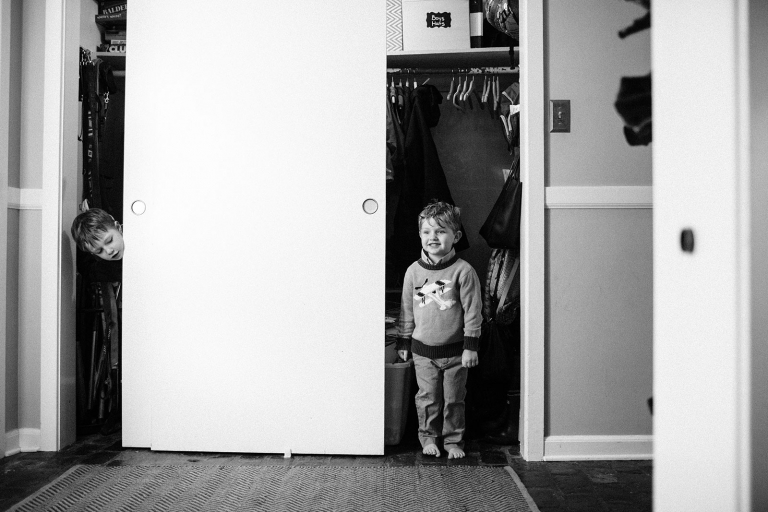 paoli family session two boys peeking out of closet