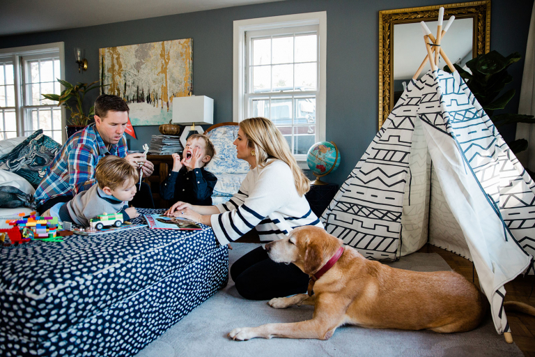 Image of family gathered around doing legos