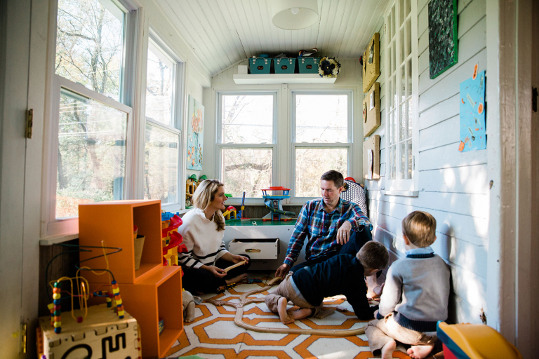 Documentary photograph of family in kids' playroom