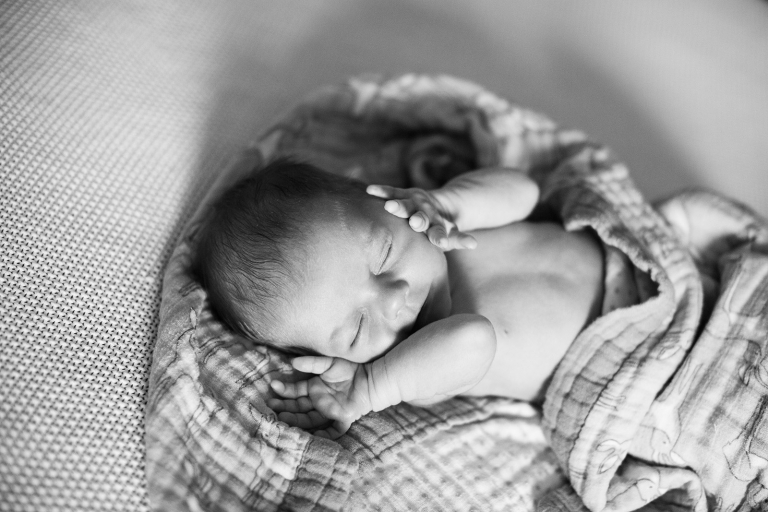 black and white cuddling newborn baby photograph