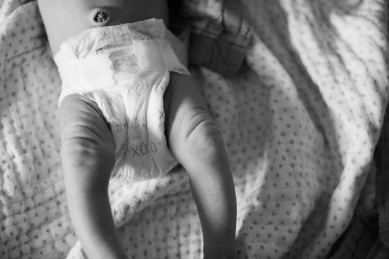 black and white newborn baby leg rolls photography