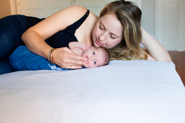 mom gazing down at newborn baby
