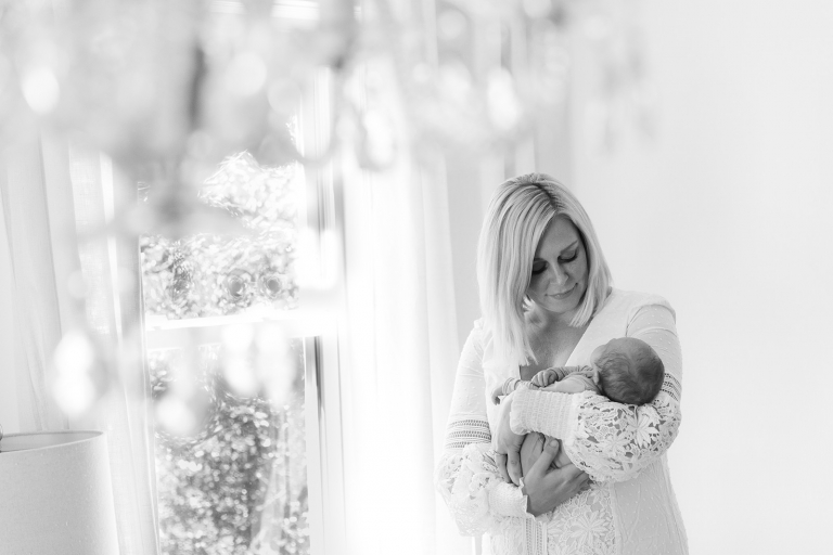 Newborn session mother gazing down at baby