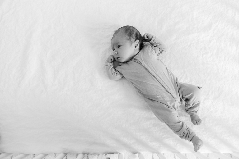 newborn baby in crib in black and white